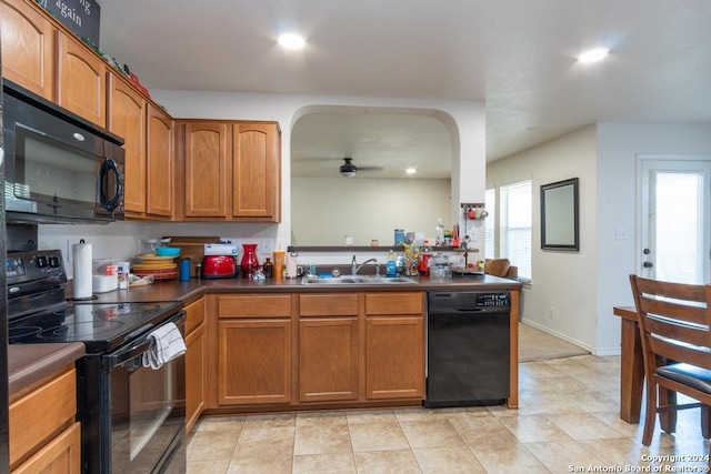 3802 Blue Oak Pass, San Antonio, TX 78223 - kitchen featuring brown cabinets, dark countertops, a sink, a ceiling fan, and black appliances