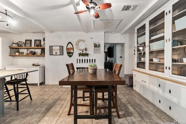 dining area featuring attic access, visible vents, a ceiling fan, and light tile patterned flooring