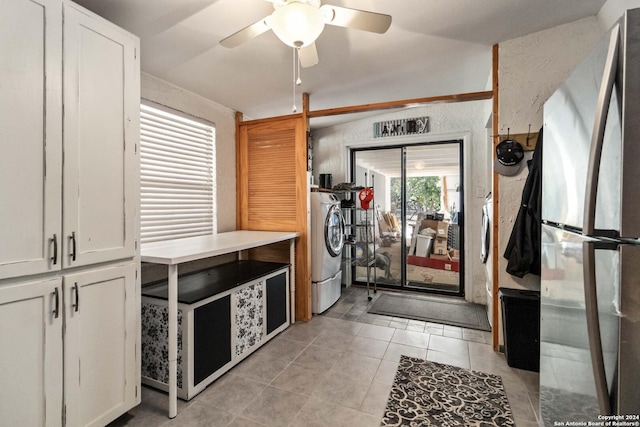 kitchen with light tile patterned floors, light countertops, freestanding refrigerator, washer / dryer, and ceiling fan