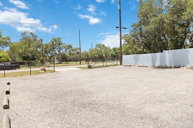 view of yard with fence and a gate