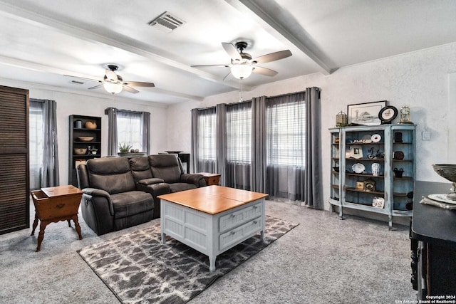 carpeted living room featuring visible vents, ceiling fan, and beam ceiling