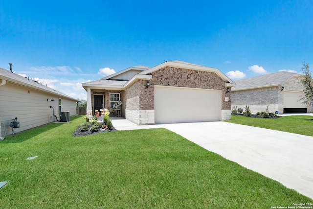 view of front facade featuring a garage, cooling unit, and a front yard