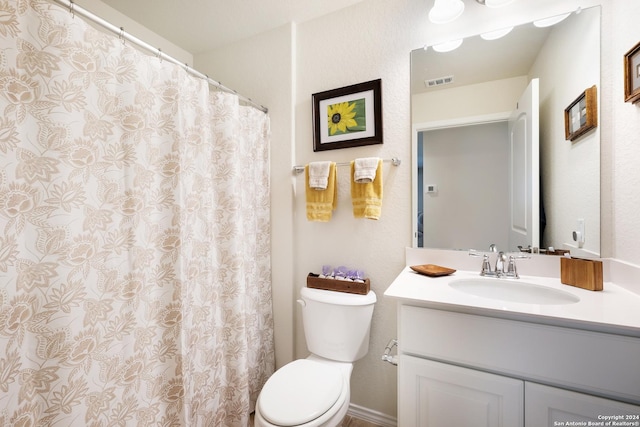 bathroom featuring visible vents, vanity, and toilet