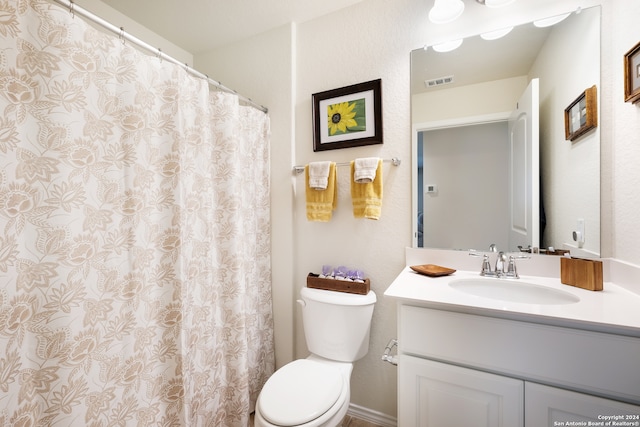 bathroom with toilet and vanity