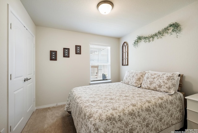 bedroom featuring carpet floors and baseboards