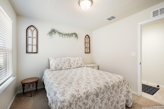 carpeted bedroom featuring visible vents and baseboards