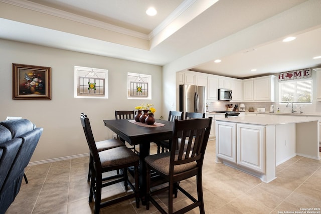 dining area featuring ornamental molding, recessed lighting, a raised ceiling, and baseboards