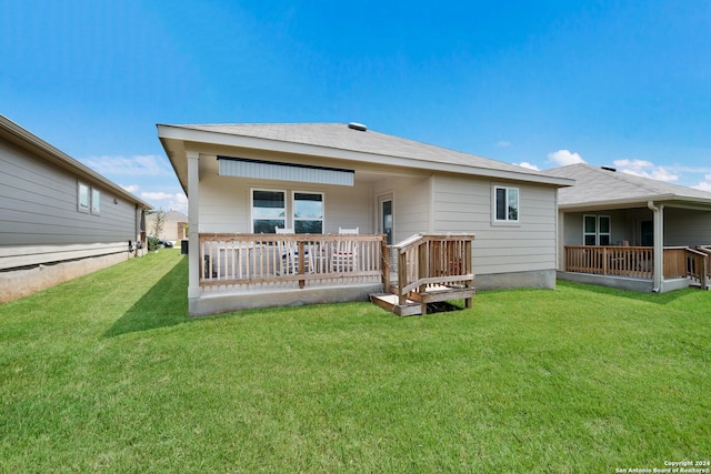 rear view of house featuring a yard