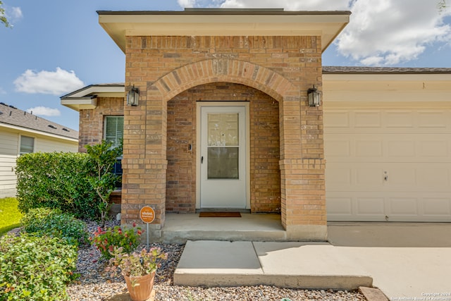 view of exterior entry with a garage