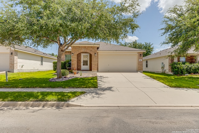 view of front of property with a garage and a front lawn