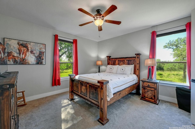 bedroom with ceiling fan and light carpet