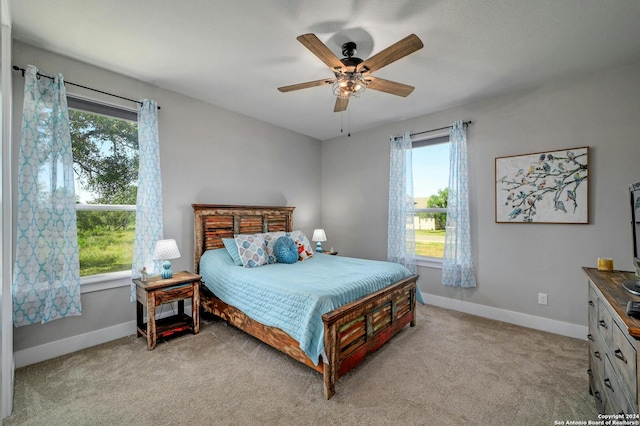 bedroom featuring ceiling fan and light carpet