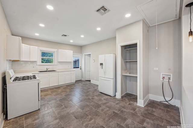 kitchen featuring decorative backsplash, white cabinets, sink, dark tile patterned flooring, and white appliances