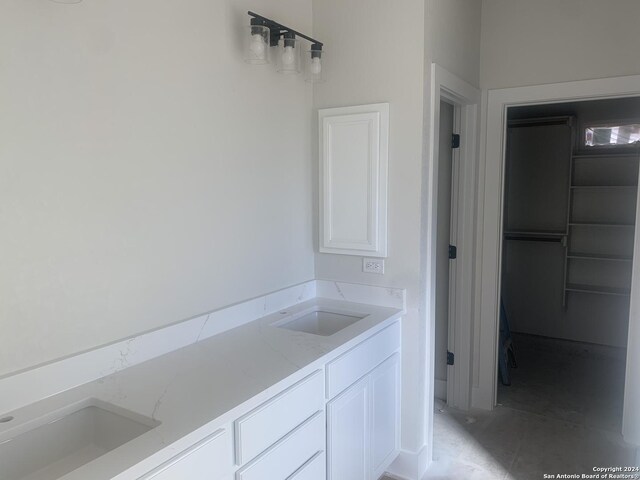 bathroom with sink and concrete floors