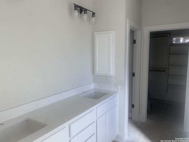 bathroom featuring double vanity and a sink