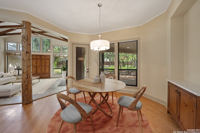 dining area with vaulted ceiling with beams, decorative columns, and light hardwood / wood-style floors