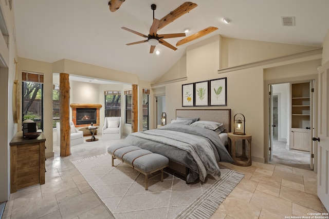 tiled bedroom with ceiling fan and high vaulted ceiling