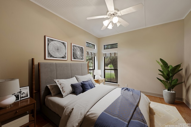 bedroom with ceiling fan, crown molding, and wood-type flooring