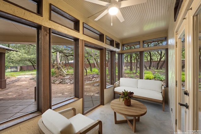 sunroom / solarium featuring ceiling fan