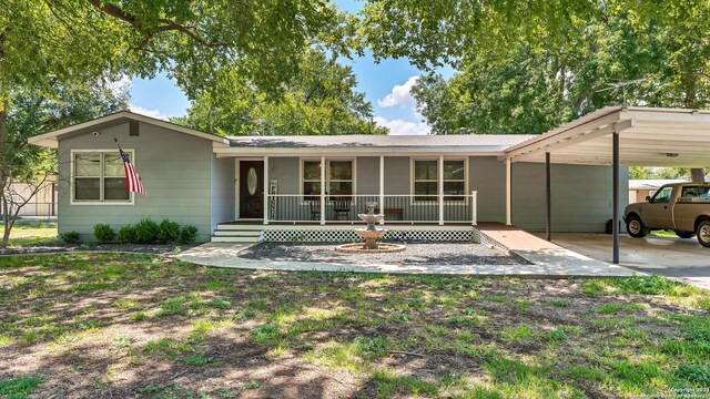 ranch-style house featuring a carport and a porch