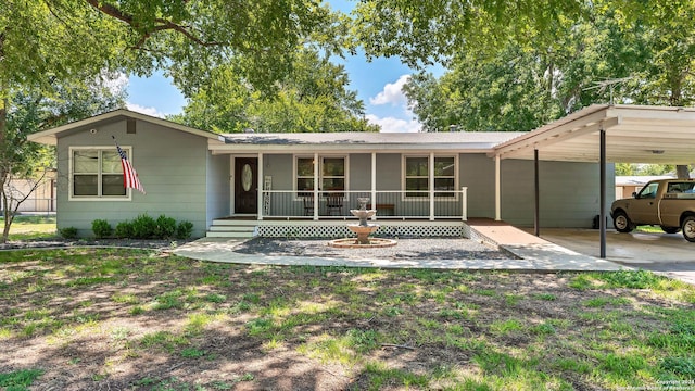 view of front of property with a porch and a carport