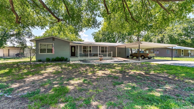 single story home with a front lawn and a carport