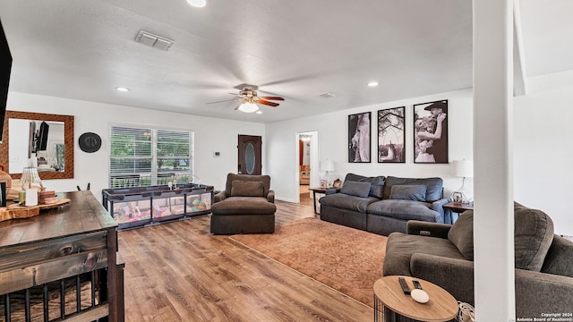 living room with recessed lighting, wood finished floors, visible vents, and a ceiling fan