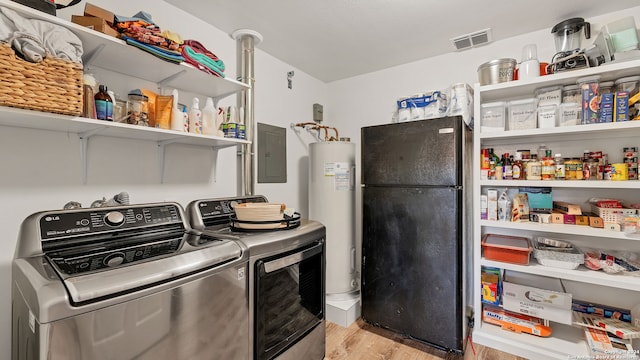 laundry room with light wood-type flooring, electric water heater, independent washer and dryer, and electric panel