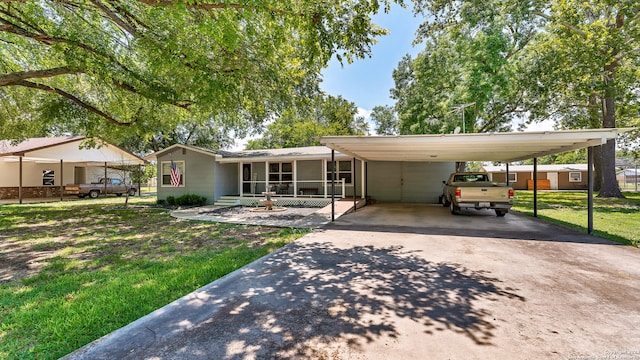 view of front of property with a carport and a front yard