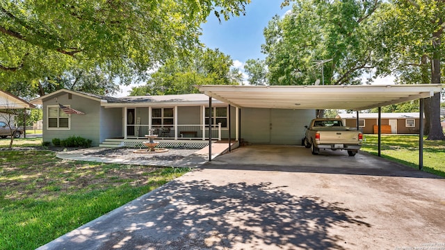 view of front facade with a carport and a front yard