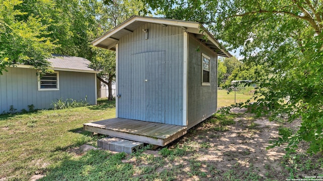 view of shed featuring fence