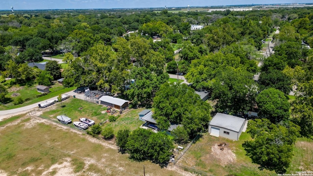 bird's eye view with a wooded view