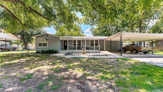 back of property with a carport