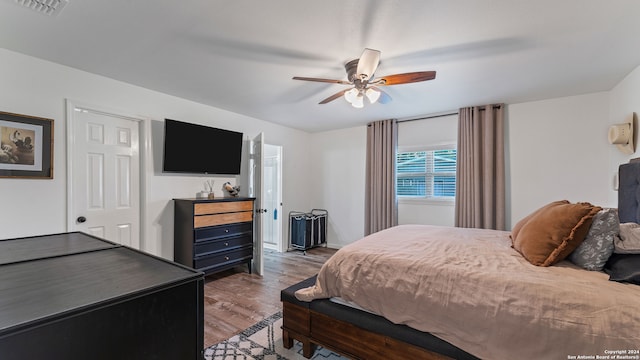 bedroom with ceiling fan and hardwood / wood-style flooring