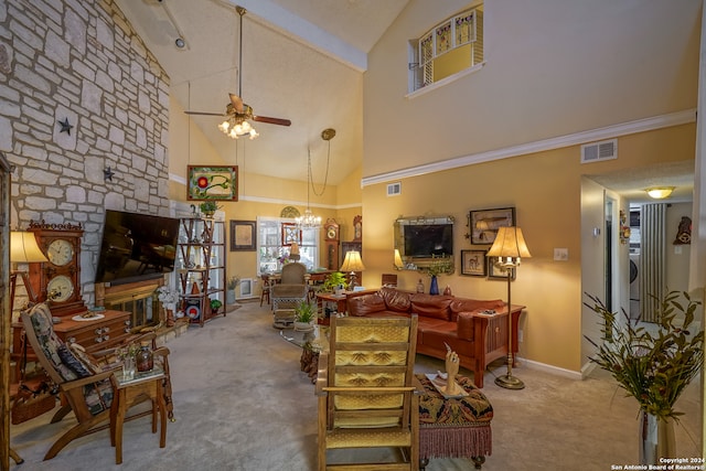 living room with ceiling fan with notable chandelier, high vaulted ceiling, a stone fireplace, and carpet flooring