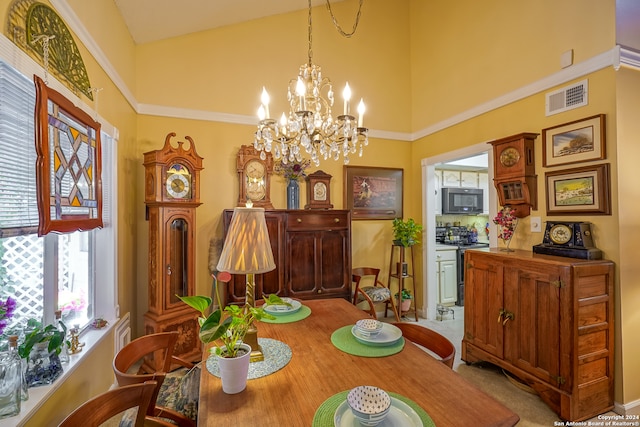 carpeted dining space featuring a high ceiling, plenty of natural light, and a notable chandelier