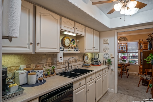 kitchen with dishwasher, tasteful backsplash, sink, light wood-type flooring, and ceiling fan