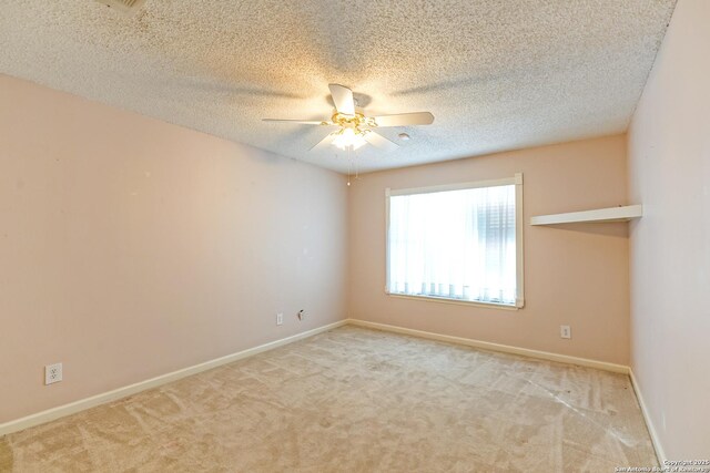 bedroom with a textured ceiling, ceiling fan with notable chandelier, and light carpet