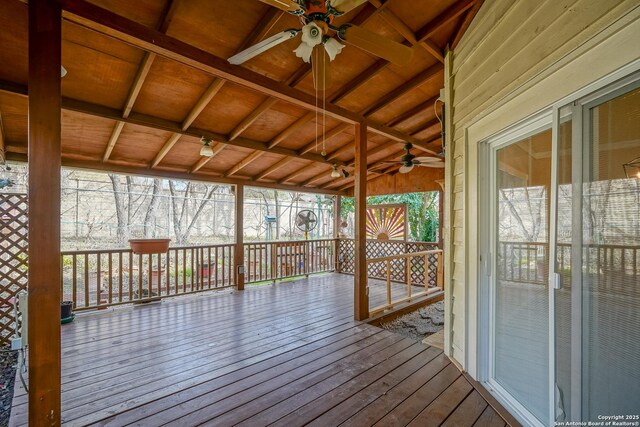 sunroom / solarium with lofted ceiling with beams, wooden ceiling, and ceiling fan