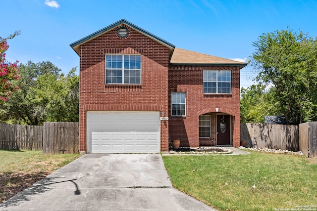 view of property featuring a front yard and a garage