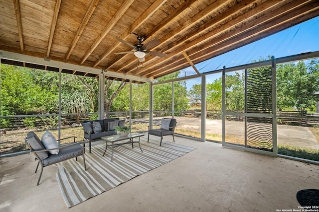 unfurnished sunroom featuring ceiling fan