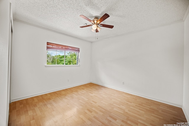 spare room featuring a textured ceiling, light hardwood / wood-style flooring, and ceiling fan