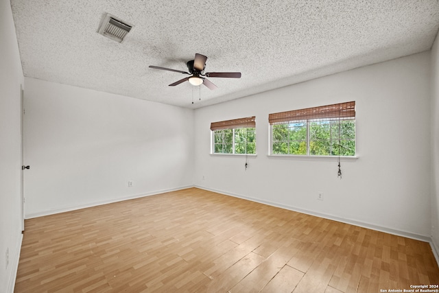 unfurnished room featuring ceiling fan, a textured ceiling, and light hardwood / wood-style floors