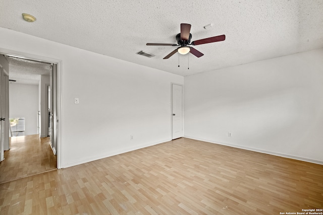 spare room with ceiling fan, a textured ceiling, and light hardwood / wood-style flooring