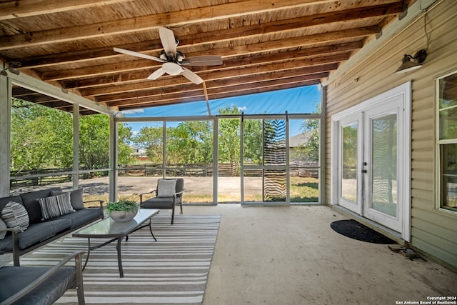 unfurnished sunroom with ceiling fan and vaulted ceiling