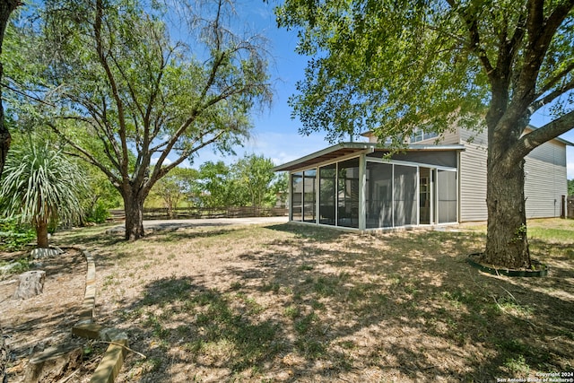 view of yard featuring a sunroom