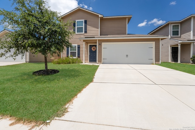 view of property with a front lawn and a garage