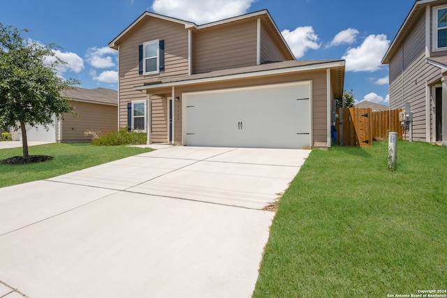 view of front of home featuring a front yard and a garage