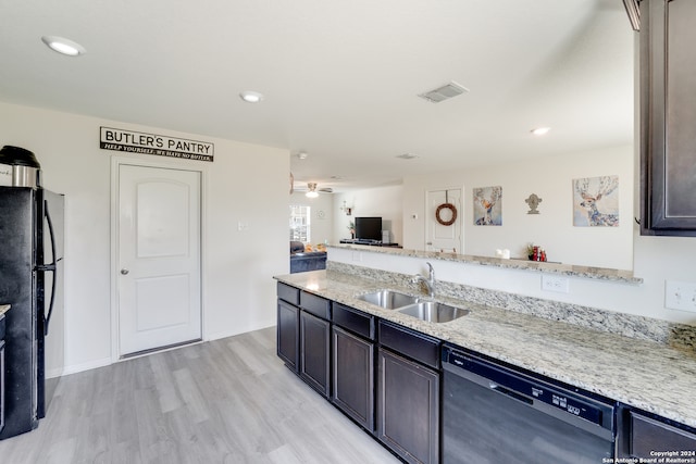 kitchen featuring ceiling fan, light wood-type flooring, light stone counters, sink, and black appliances