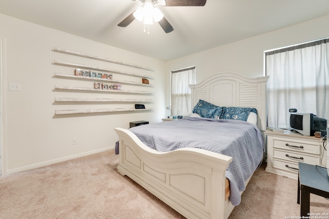 bedroom featuring ceiling fan and light carpet